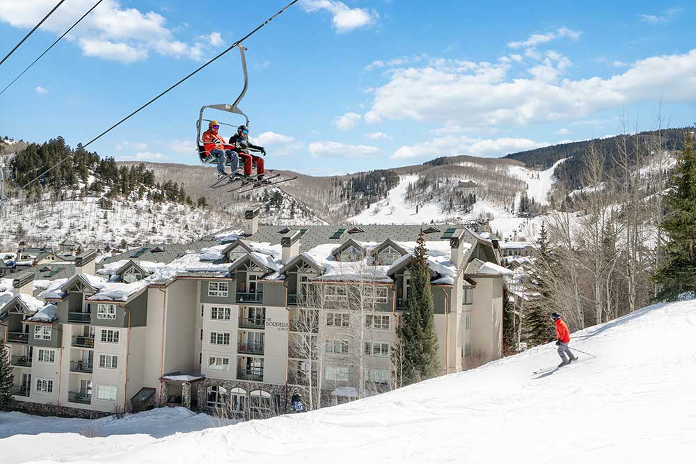 Skiers on lift next to Borders Lodge